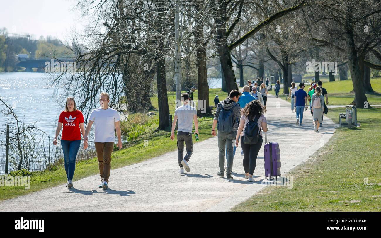 Muenster, North Rhine-Westphalia, Germany - Leisure time at the Aasee in times of the corona crisis, young people take a walk at the Aasee in complian Stock Photo