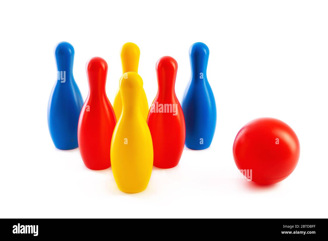 Bowling game. Skittles and ball toys isolated on white background. Stock Photo