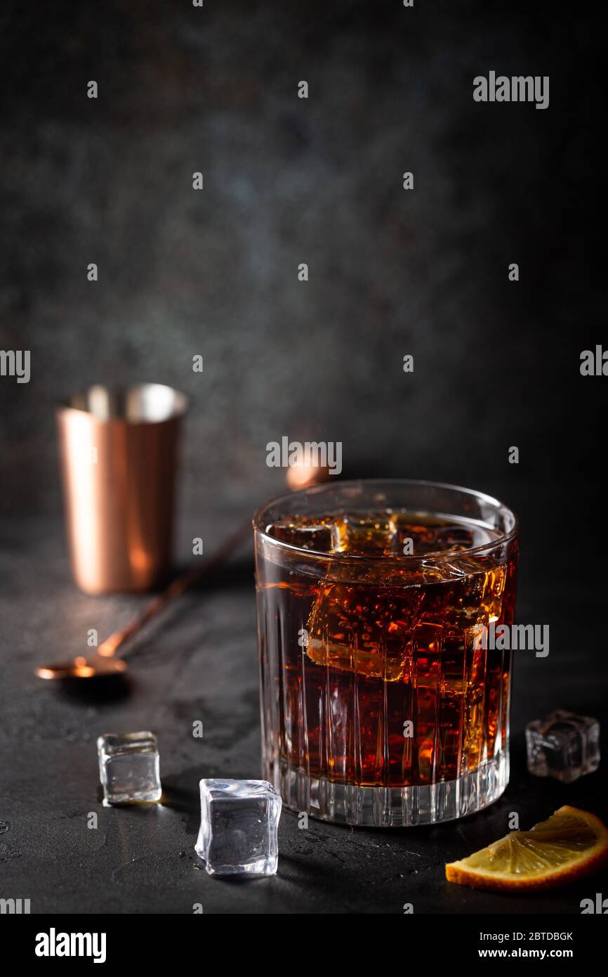 Glass of cold cola with ice cubes on dark background Stock Photo - Alamy