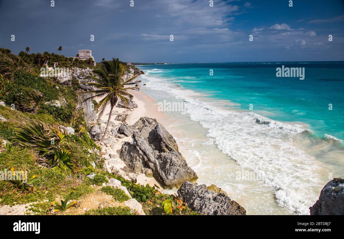 Stunning Caribbean Beach with blue sky and ancient Mayo temple in Tulum, Mexico, archeological site Stock Photo
