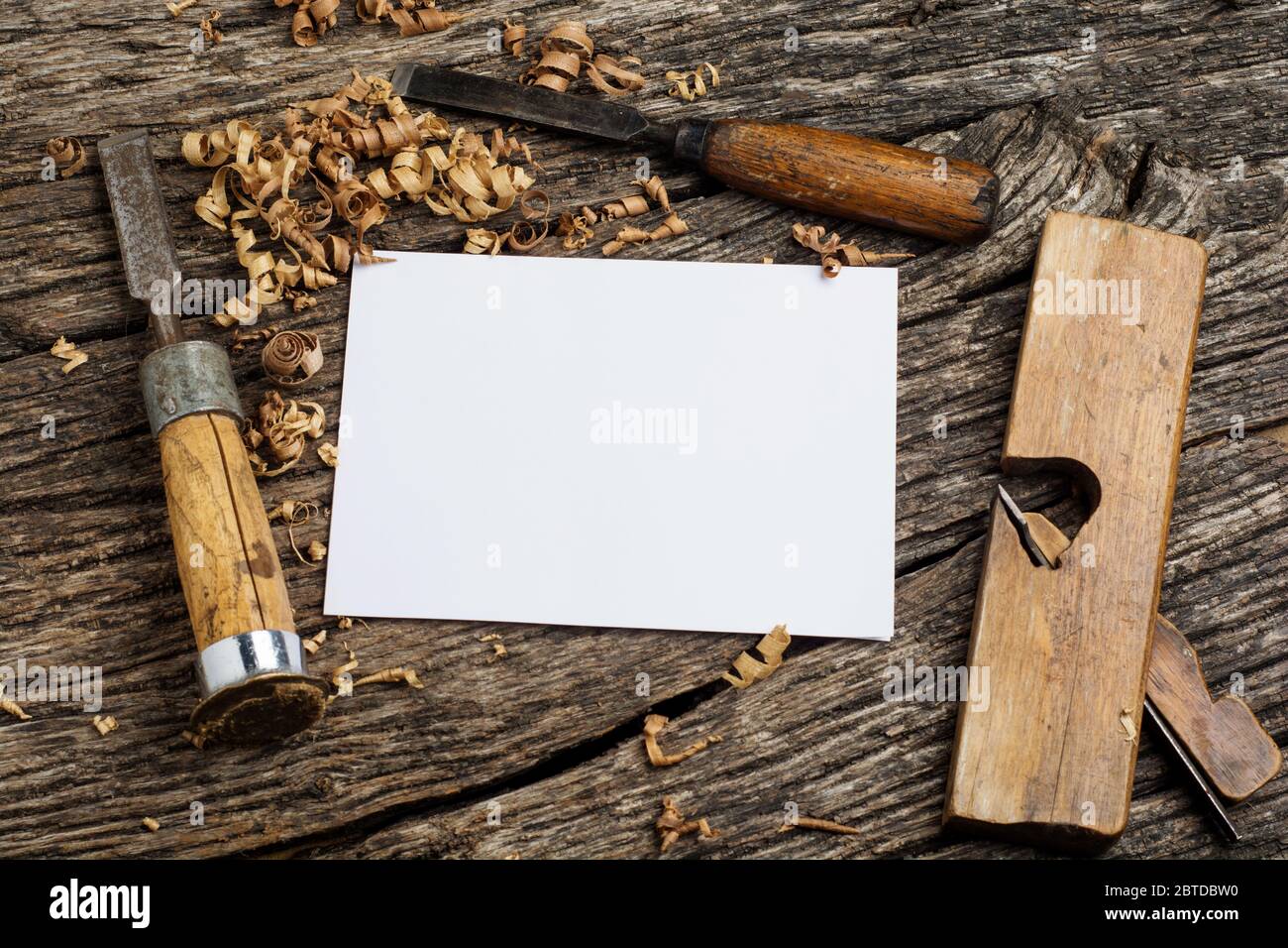 carpenter tools on dark rustic table with blank paper. Stock Photo