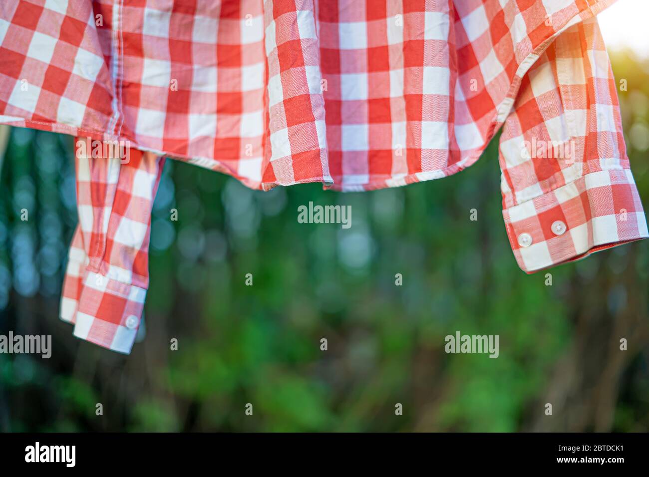 red plaid shirt dries after washing Stock Photo Alamy