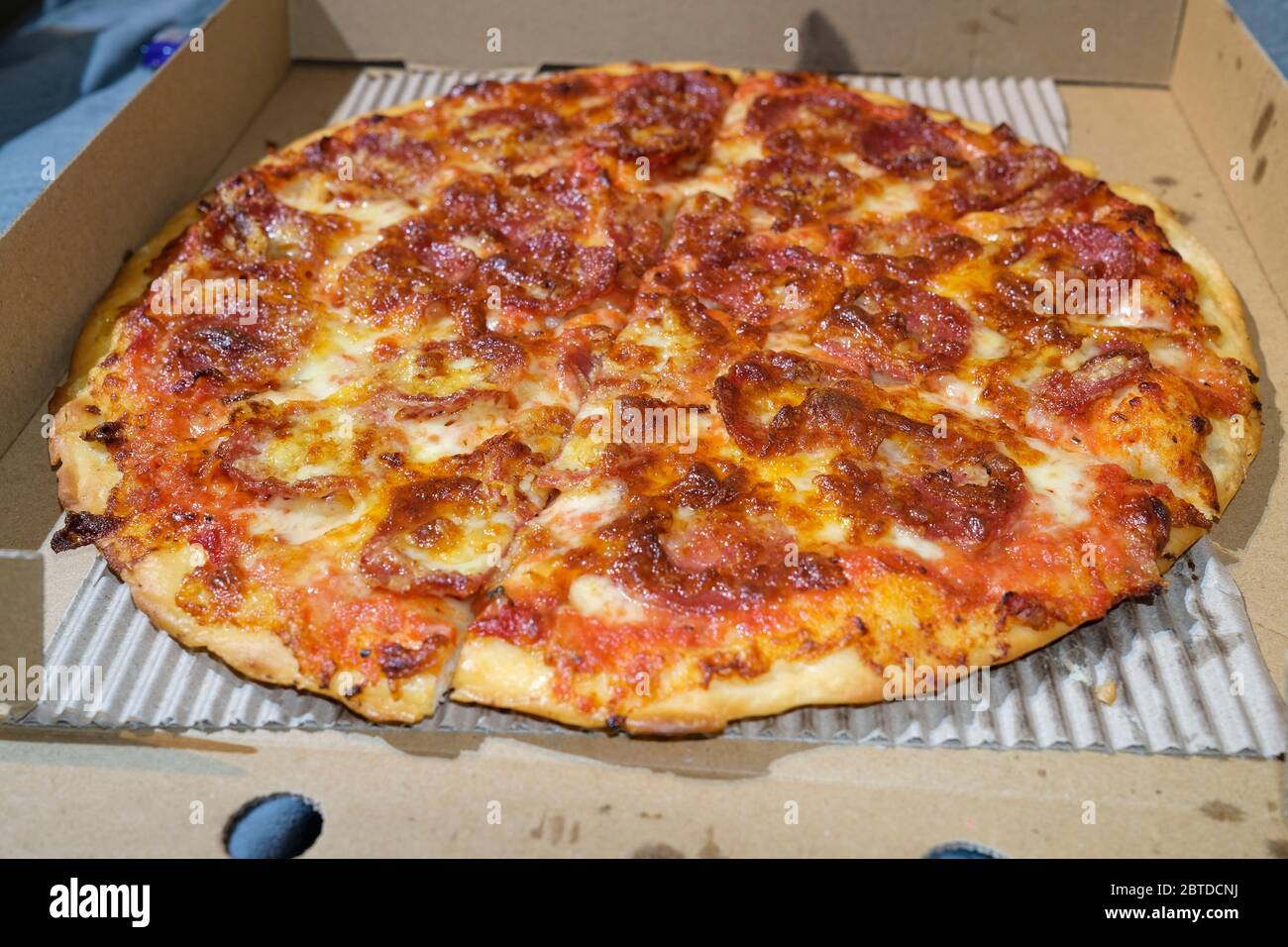 Greasy takeout Pepperoni pizza in carboard box Stock Photo