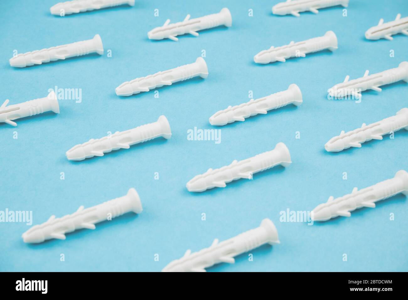White dowels on blue background. Close up. Stock Photo