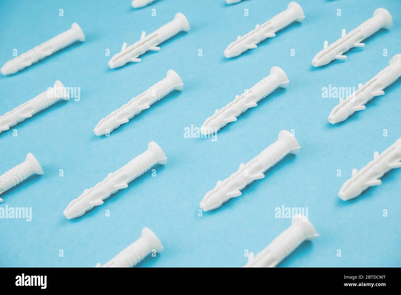 White dowels on blue background. Close up. Stock Photo