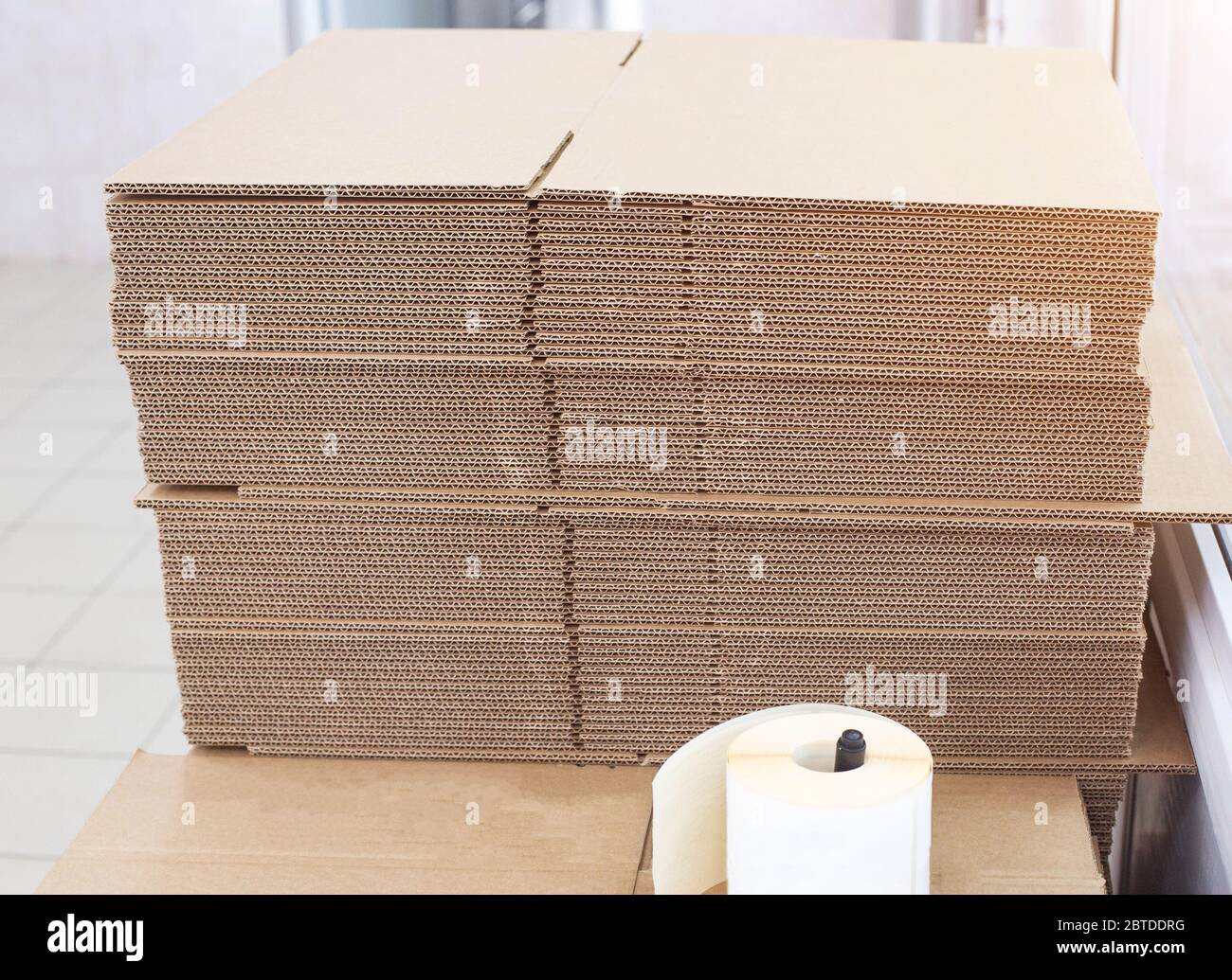 A stack of cardboard sheets for packing boxes in production. Pulp