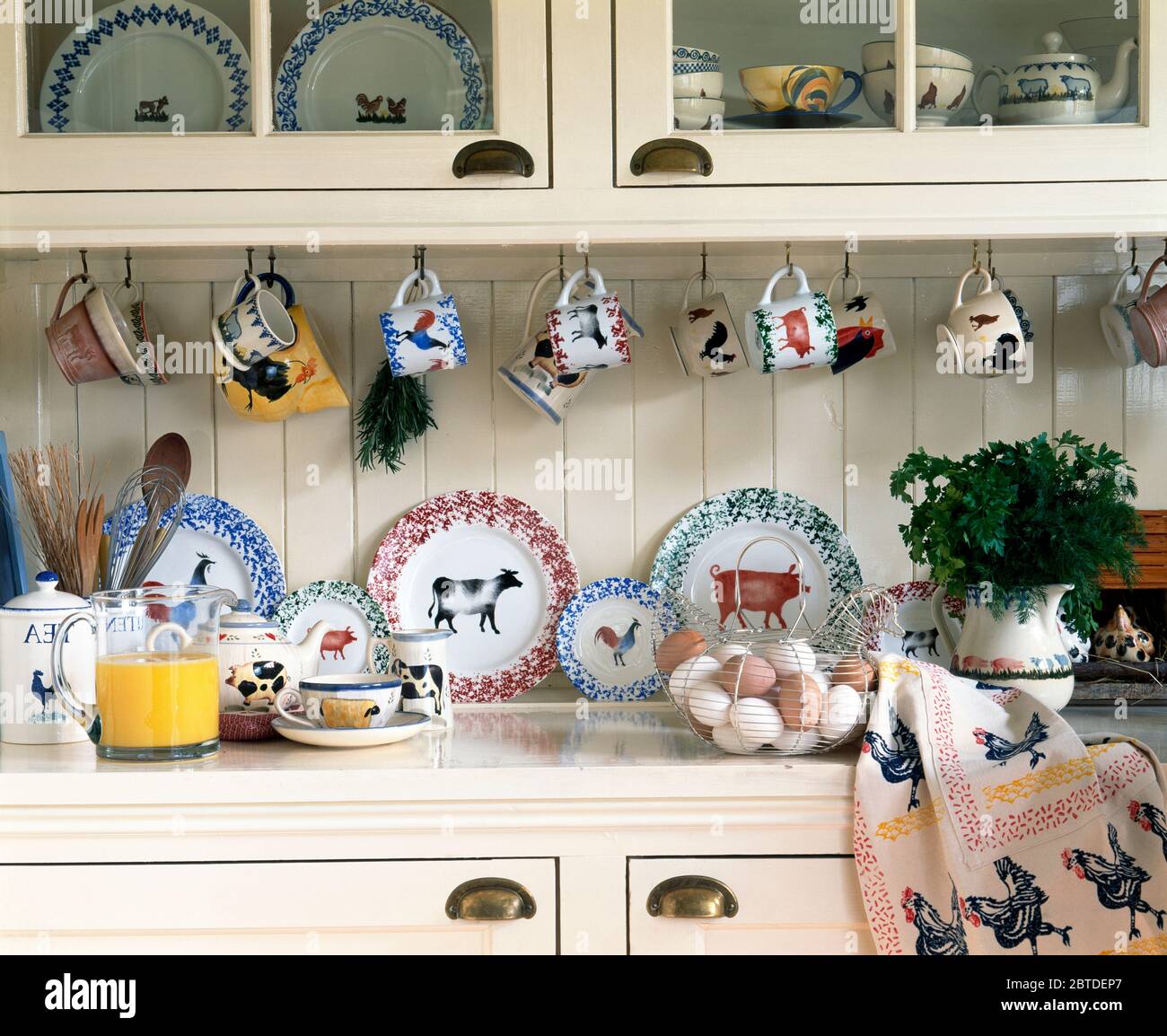 Collection of country pottery on white dresser Stock Photo