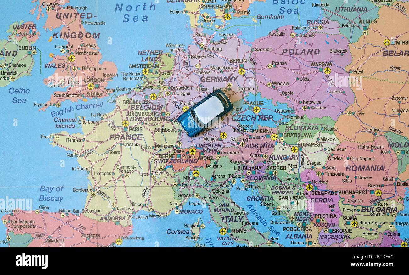 Small toy retro car in the middle of Europe map. Travel by car concept ...