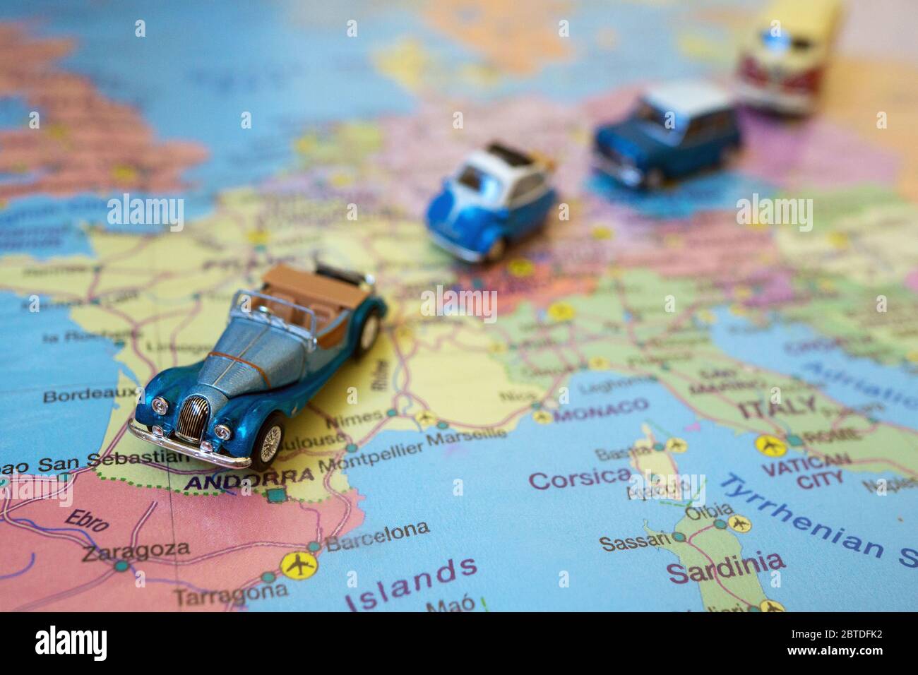 Set of small toy retro cars on the Europe map. Travel by car concept. Stock Photo