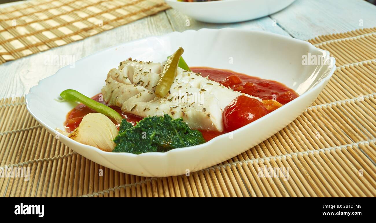 Herb  garlic baked cod with romesco sauce and  spinach Stock Photo
