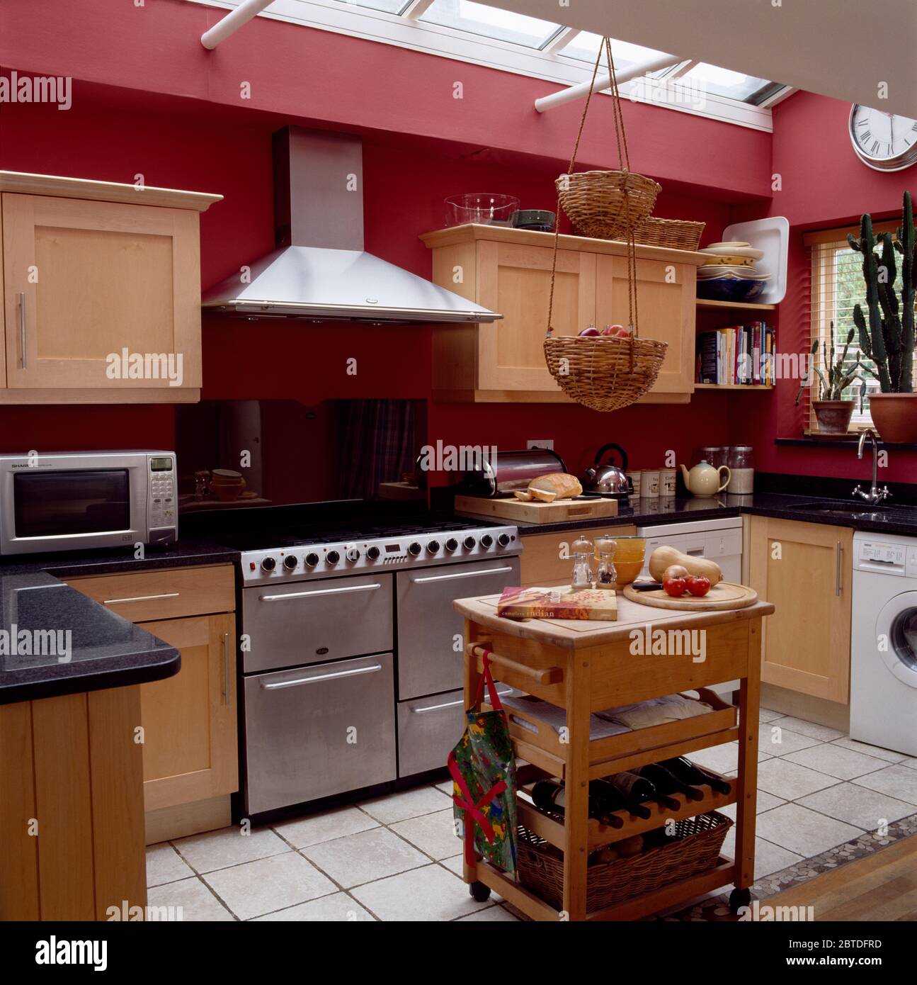 Butcher's block in modern red kitchen with range oven Stock Photo