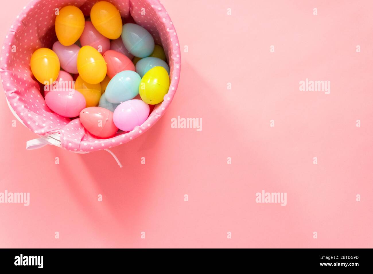 Flat lay. Easter basket with easter eggs on a pink background Stock ...