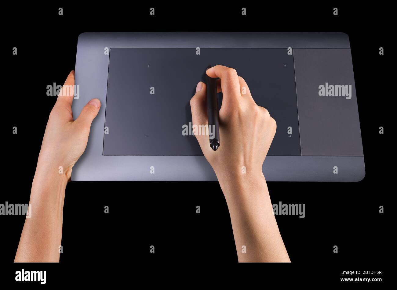 Hand holding digital graphic pen and drawing graphic tablet for illustrators, designers and