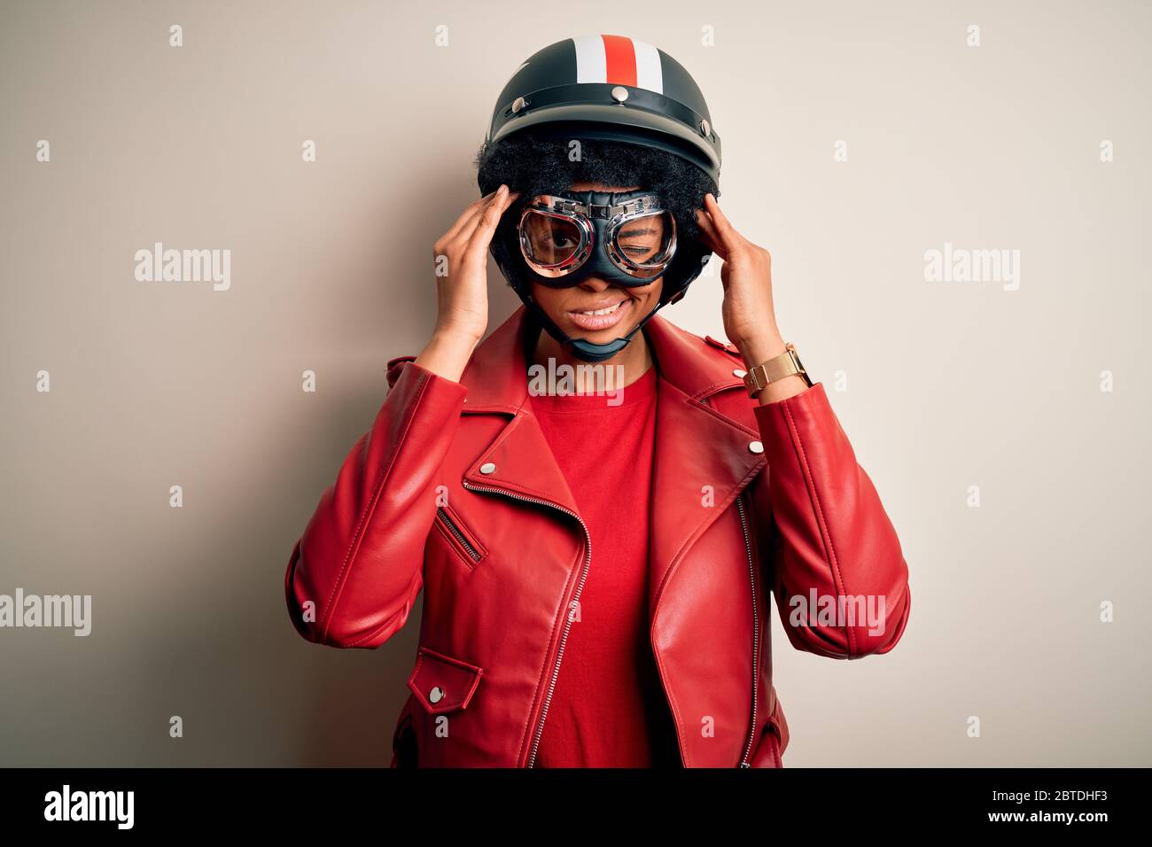 Young African American afro motorcyclist woman with curly hair wearing
