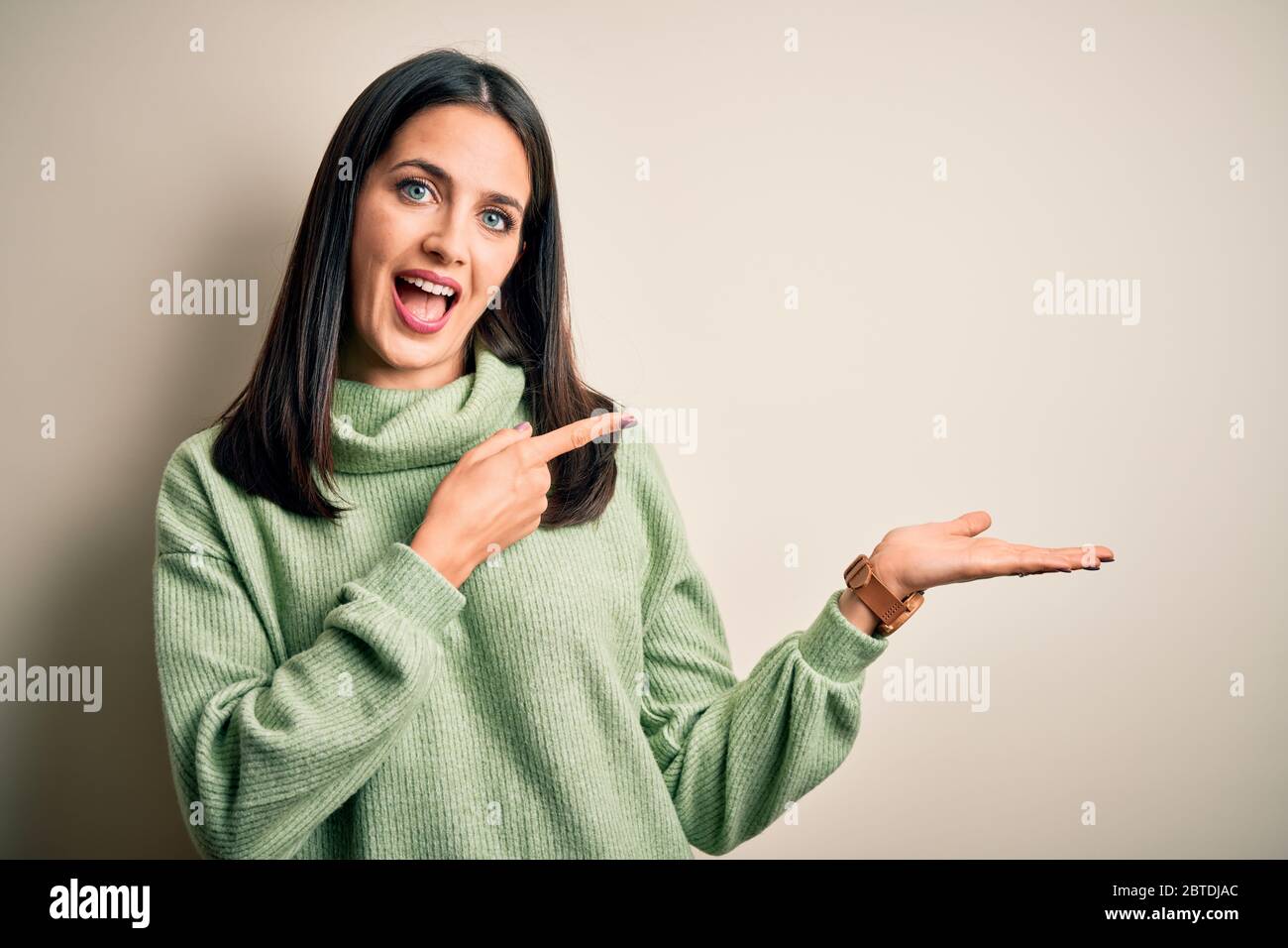 Young brunette woman with blue eyes wearing turtleneck sweater over ...