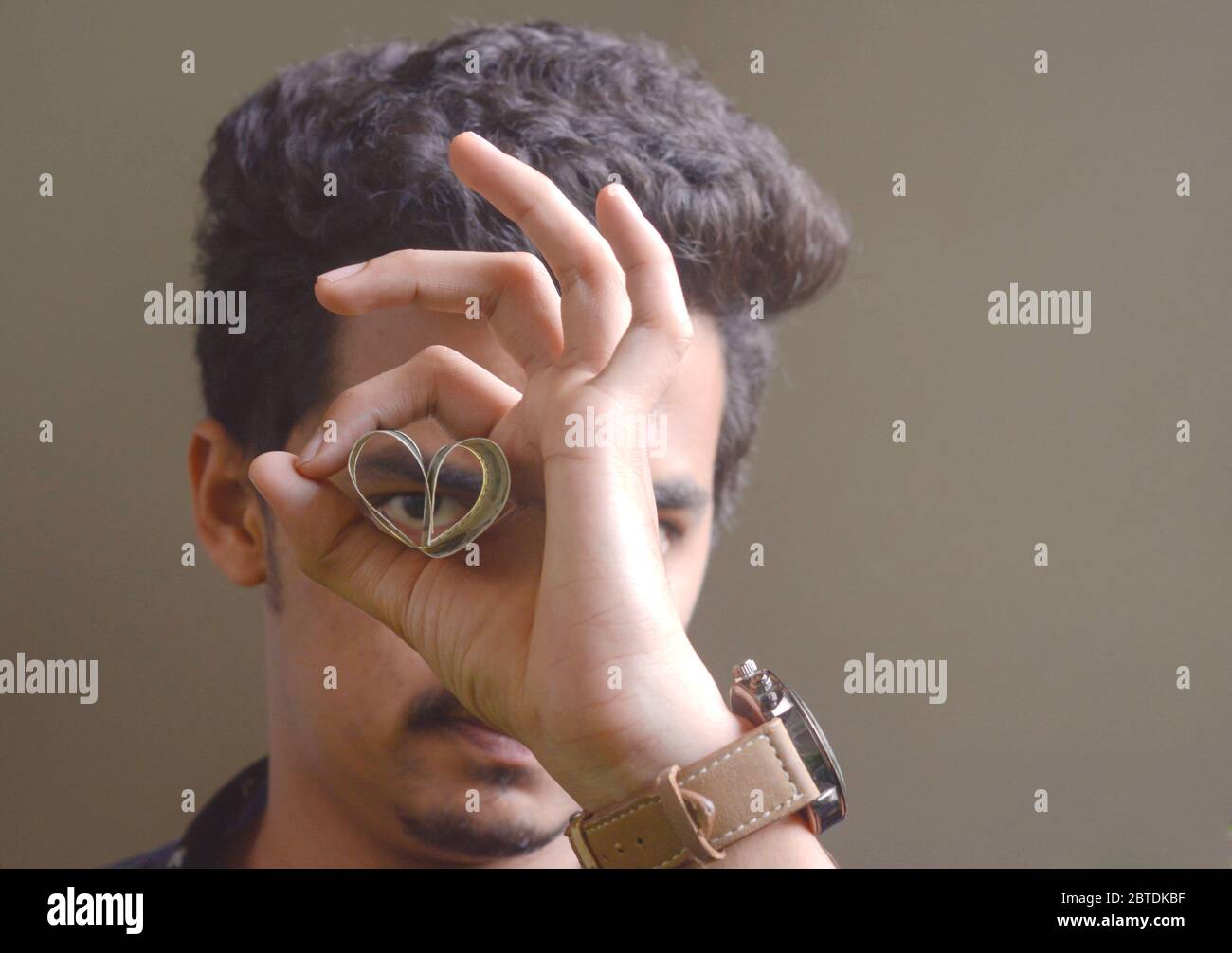 A young man showing dollar in attractive way , stylish hand movements of man . Stock Photo