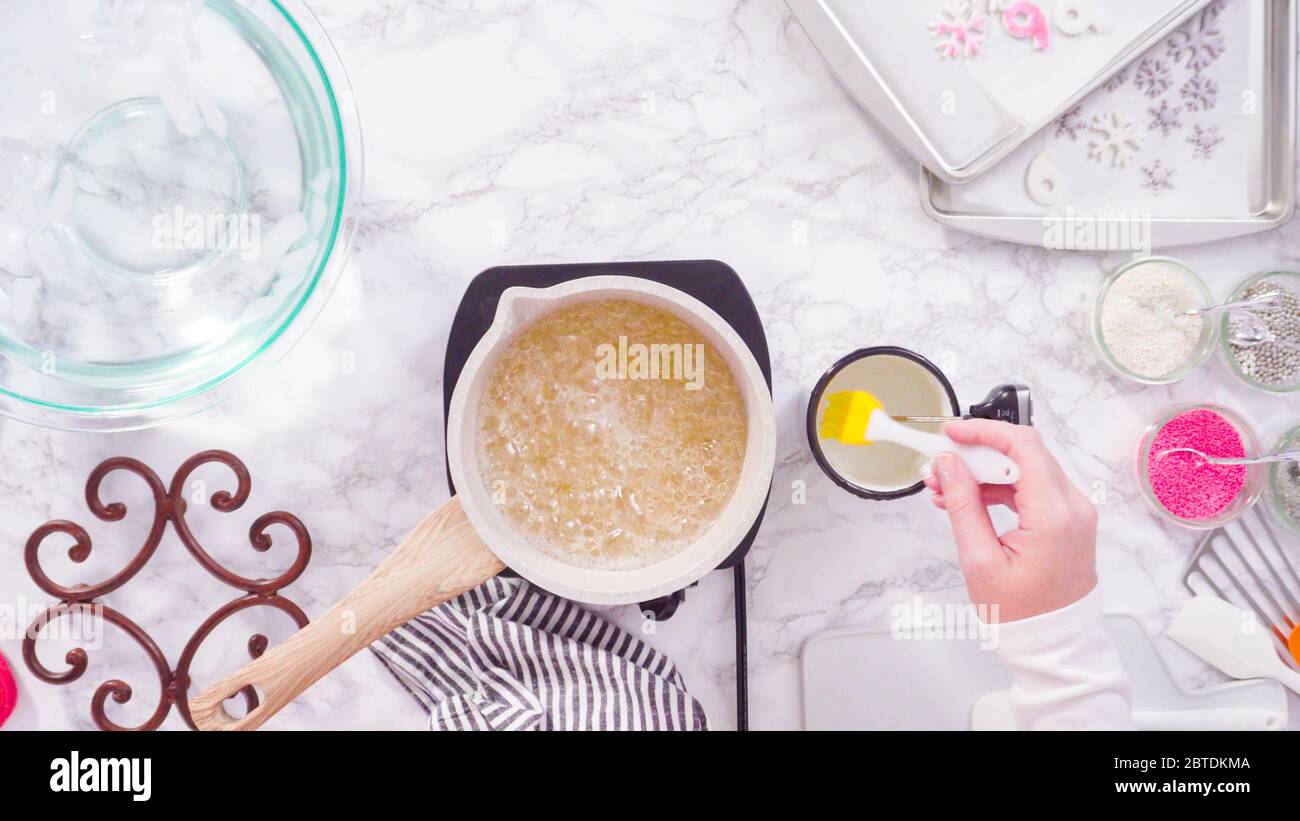 Flat lay. Step by step. Caramelizing sugar in a small cooking pot over ...