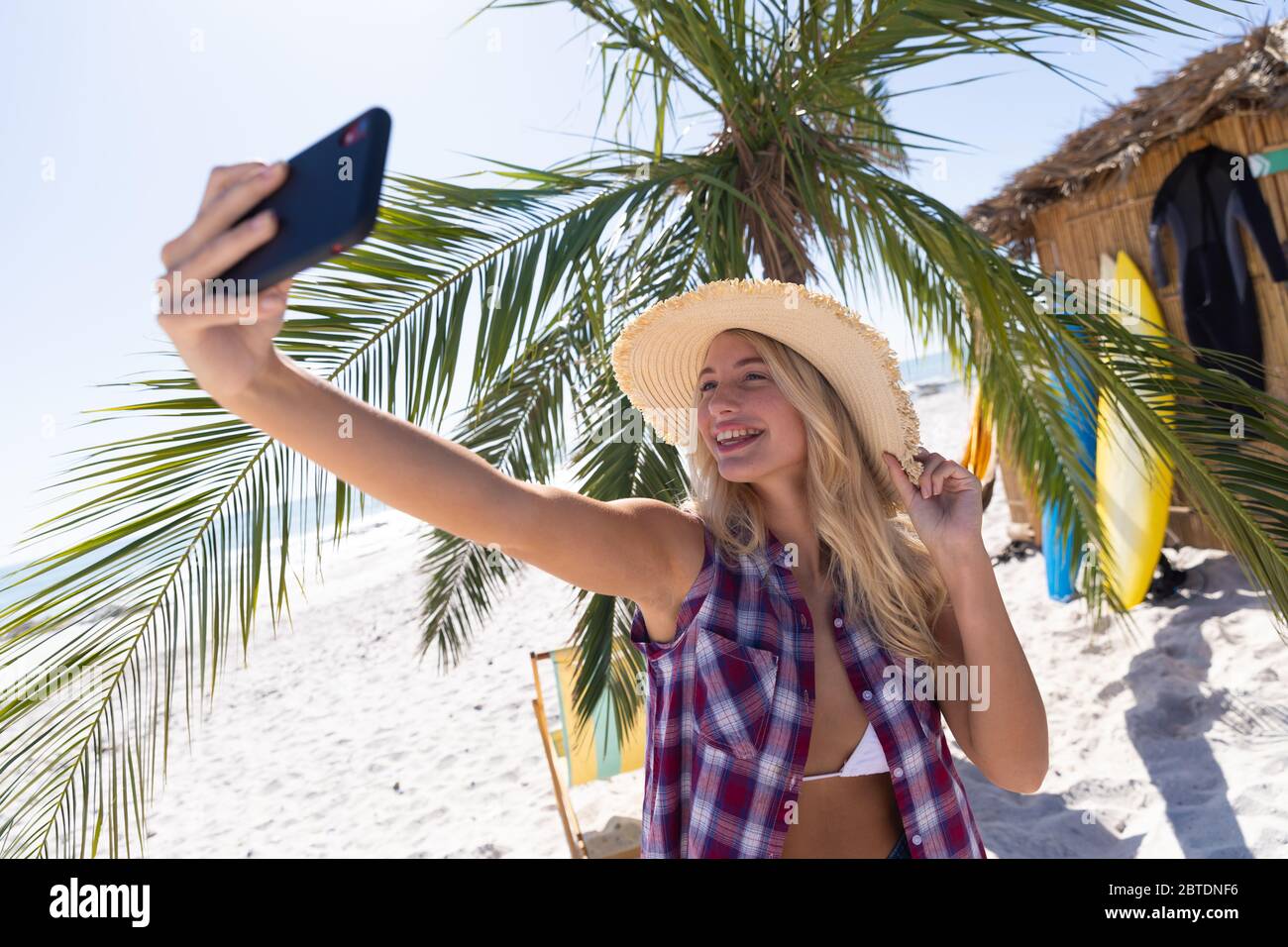 Caucasian woman taking a selfie at the beach Stock Photo