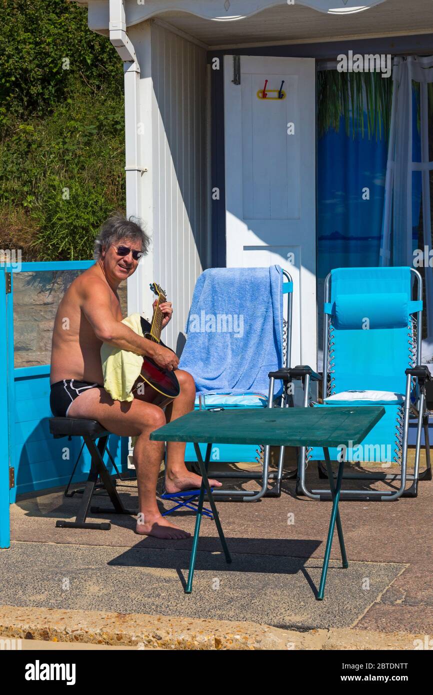 Bournemouth, Dorset UK. 25th May 2020. UK weather: scorching hot at Bournemouth beaches with clear blue skies and unbroken sunshine, as temperatures soar on Bank Holiday Monday. Sunseekers flock to the seaside, getting there early to get a good spot, as beaches get packed. Starting the day with a tune. Credit: Carolyn Jenkins/Alamy Live News Stock Photo
