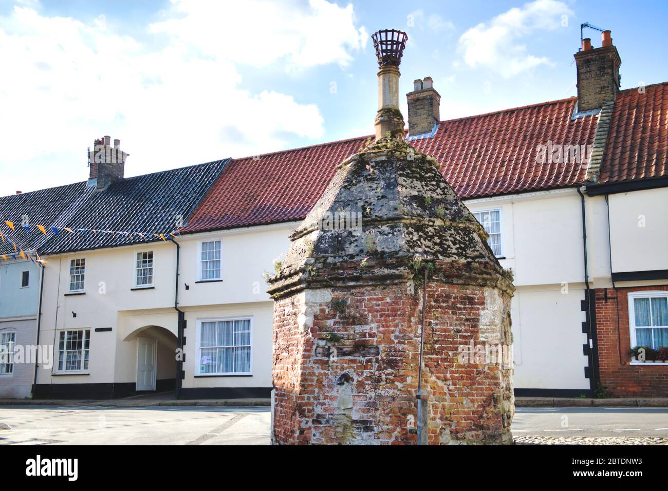 The Pump at Common Place, Little Walsingham, Norfolk, UK. The old village pump house for drawing