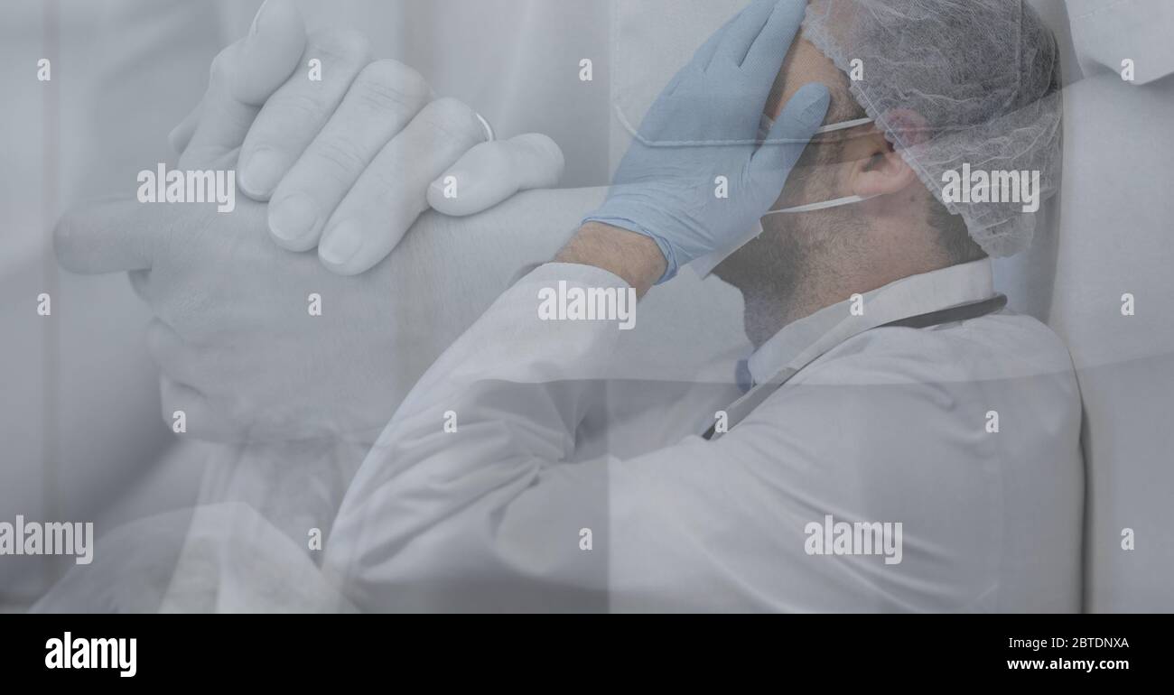 Sad Healthcare worker and holding habds during coronavirus Covid19 pandemic Stock Photo