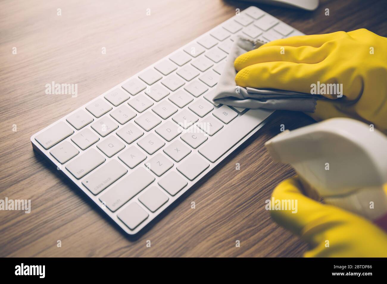 Hand of man cleaning keyboard computer with antibacterial for protect epidemic disease covid19