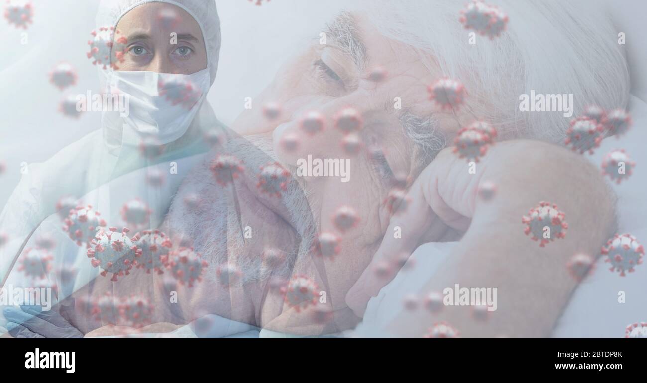 Healthcare worker wearing face mask over macro coronavirus covid19 cells spreading Stock Photo