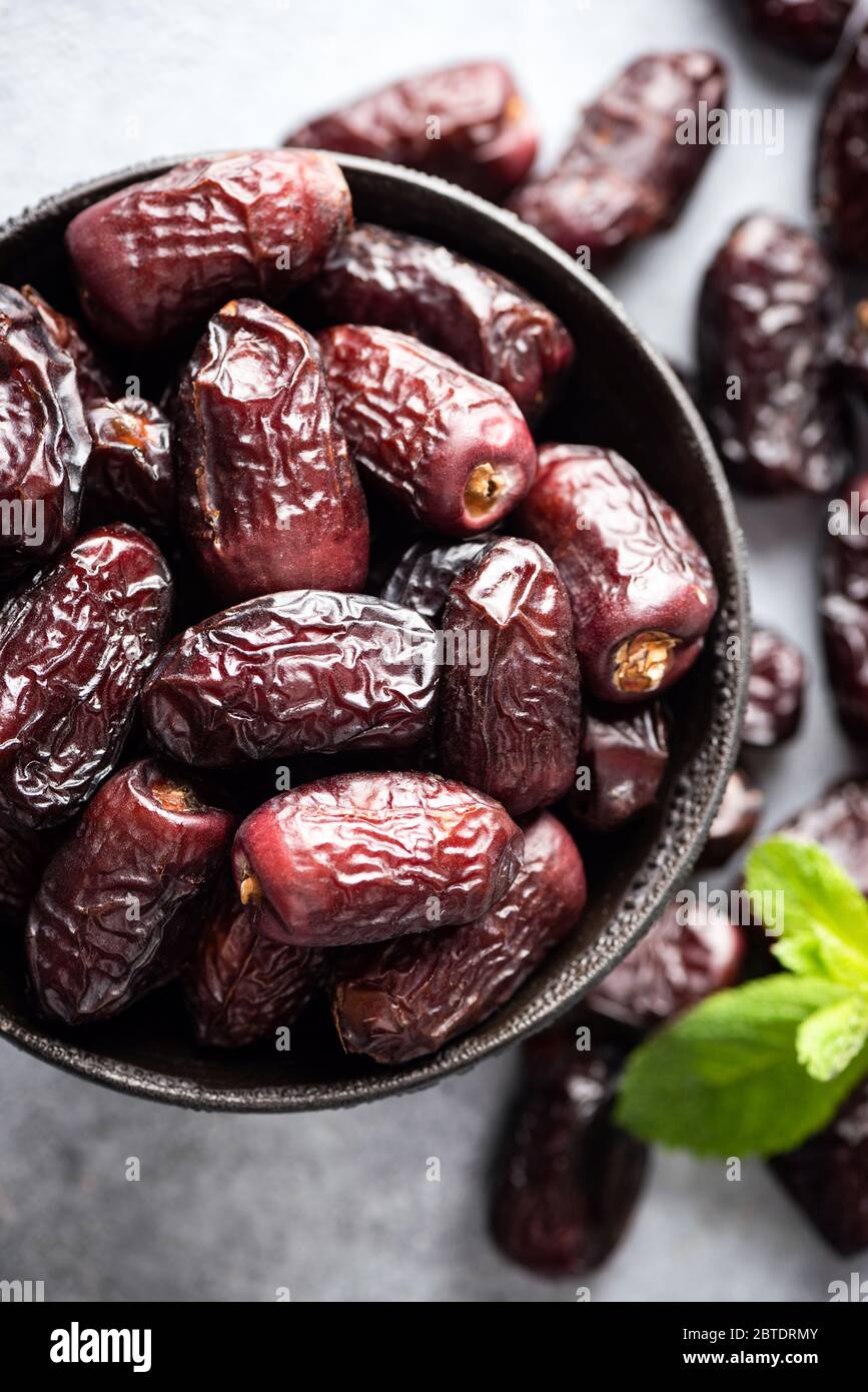 Dried Medjool Dates In Bowl Top View Closeup. Healthy Vegan Food