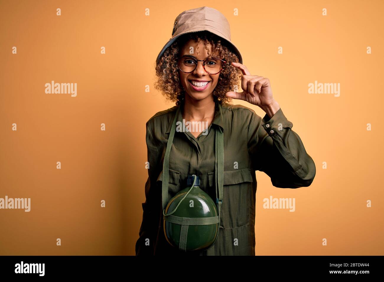 Young african american tourist woman on vacation wearing explorer hat ...