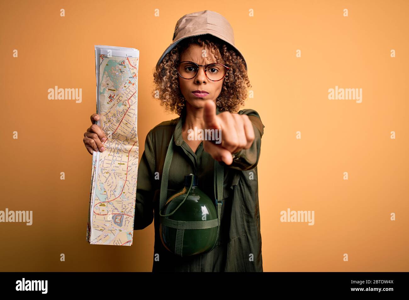 African american tourist woman wearing explorer hat and water canteen ...