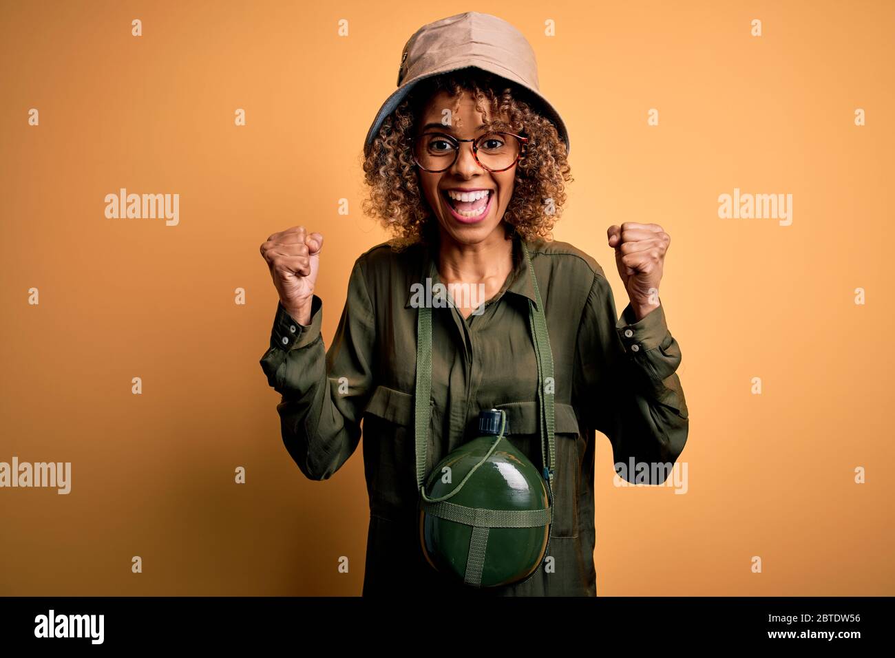Young african american tourist woman on vacation wearing explorer hat ...