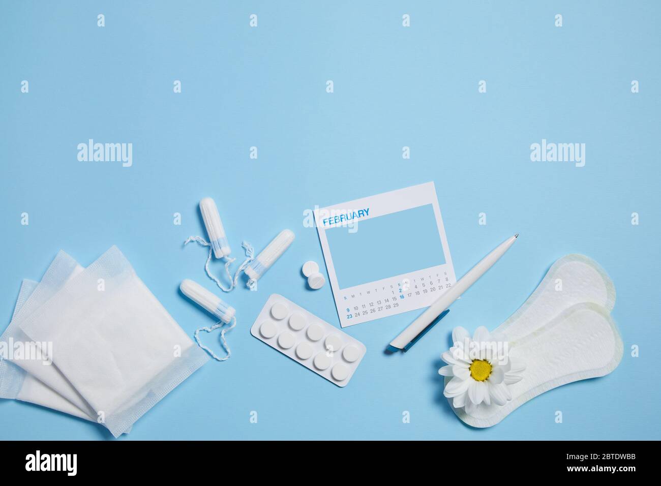 menstrual tampon, pad, pain pills during menstruation and white