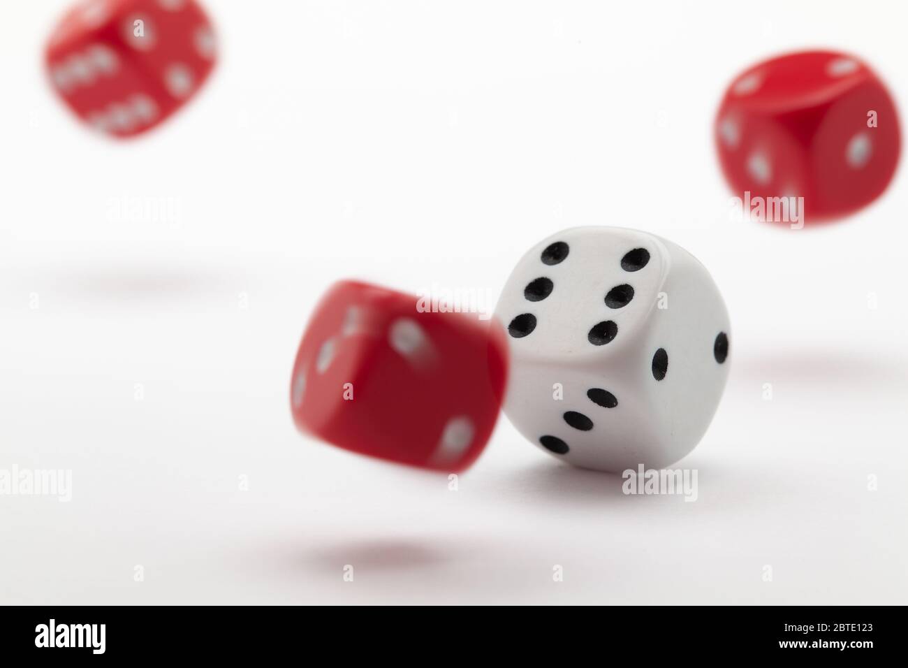 Playing dice at white wooden background. Playing a game with dice