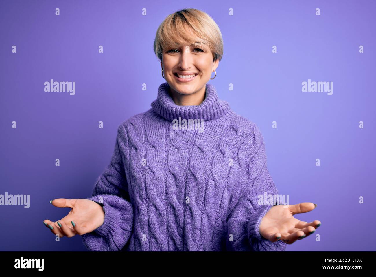 Young blonde woman with short hair wearing winter turtleneck sweater ...