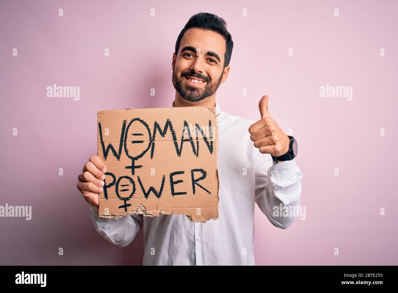 Activist man with beard asking for women rights holding banner with ...