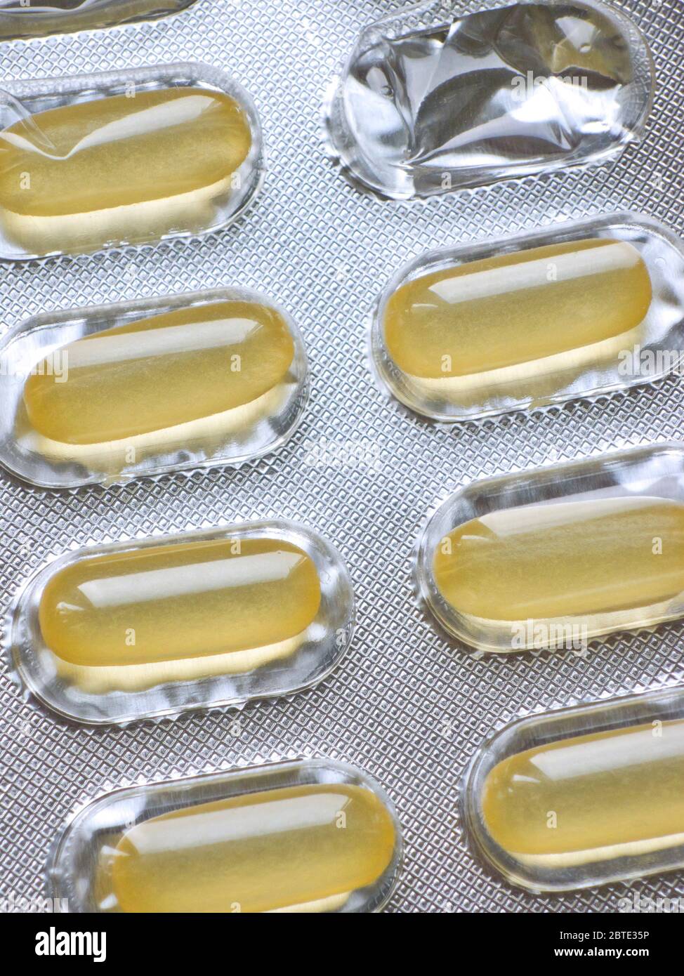 yellow pills medicine, softgel capsules in blister pack Stock Photo