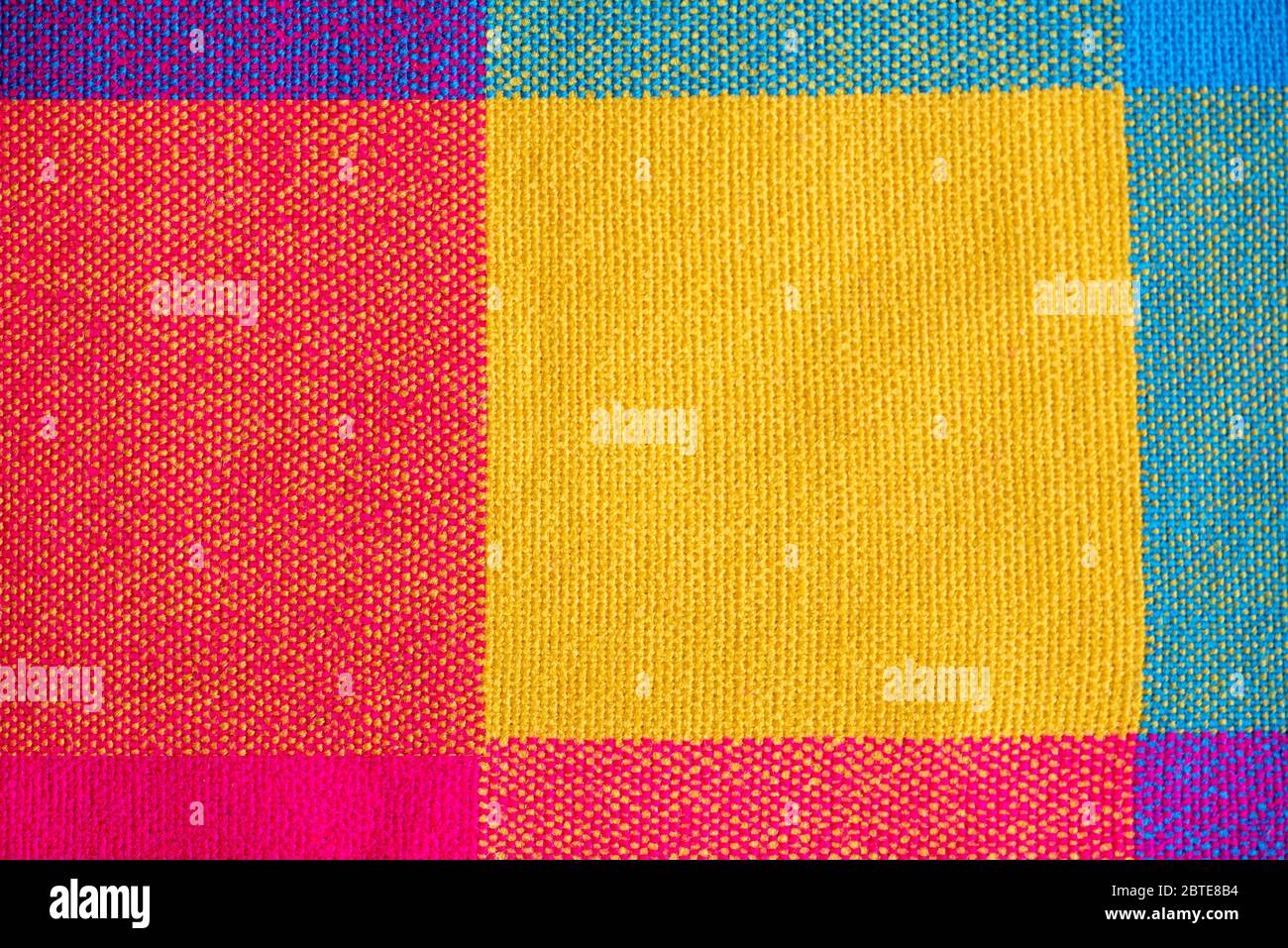 Colored fabric, cloth with abstract checkered pattern, as texture or background, top view Stock Photo