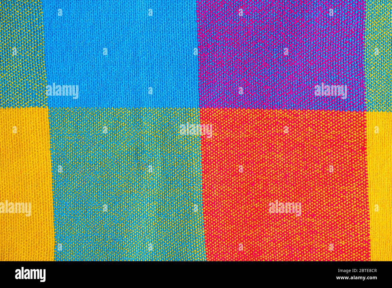 Colored fabric, cloth with abstract checkered pattern, as texture or background, top view Stock Photo