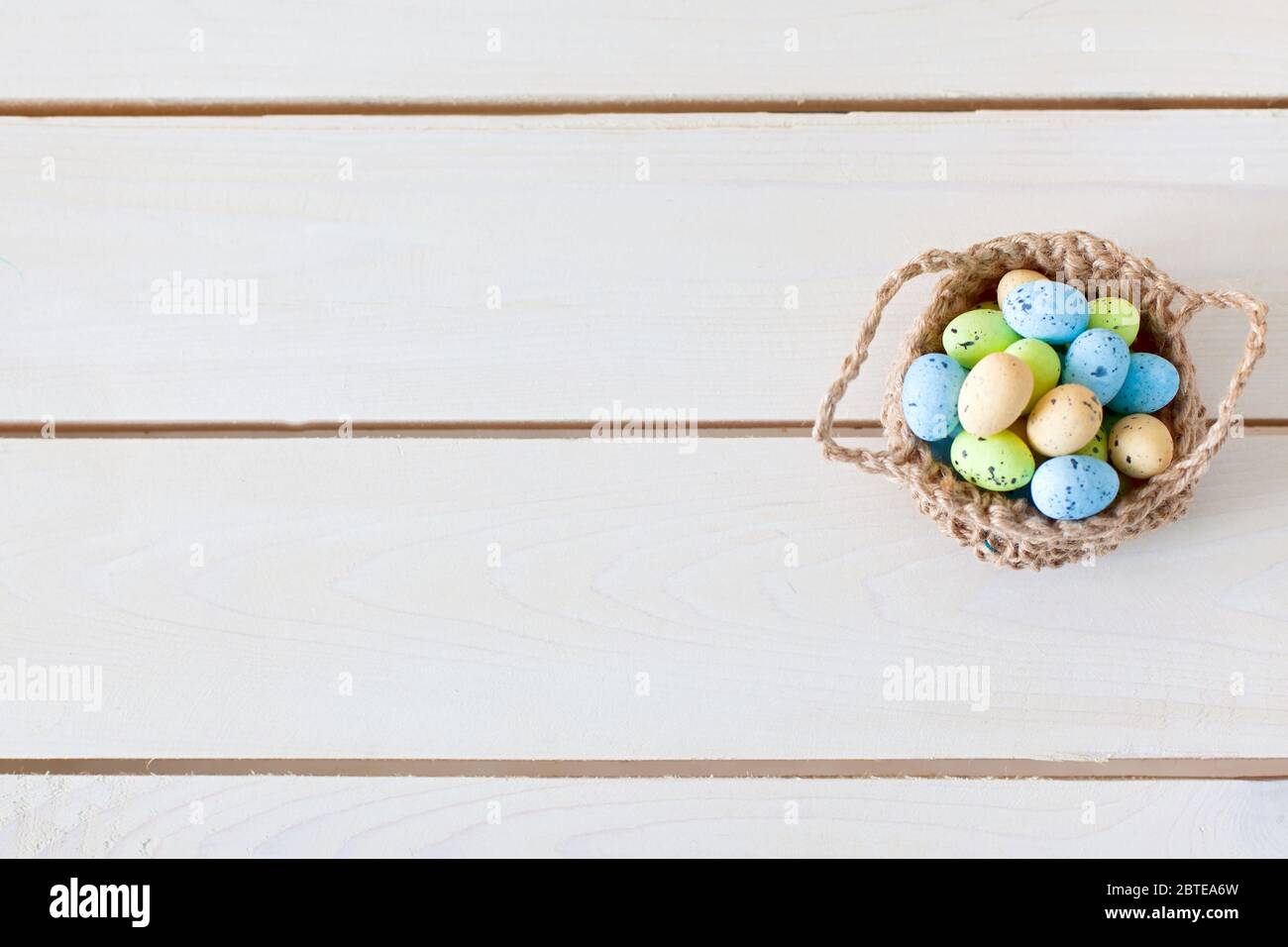 Basket with Easter eggs. Nest for eggs. handmade toy. Stock Photo