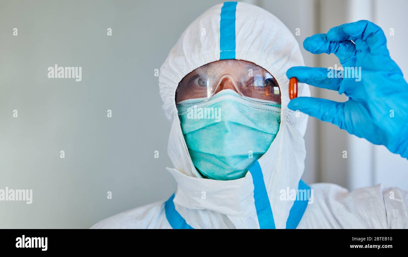 Researcher holds medication to treat Covid-19 and coronavirus Stock Photo