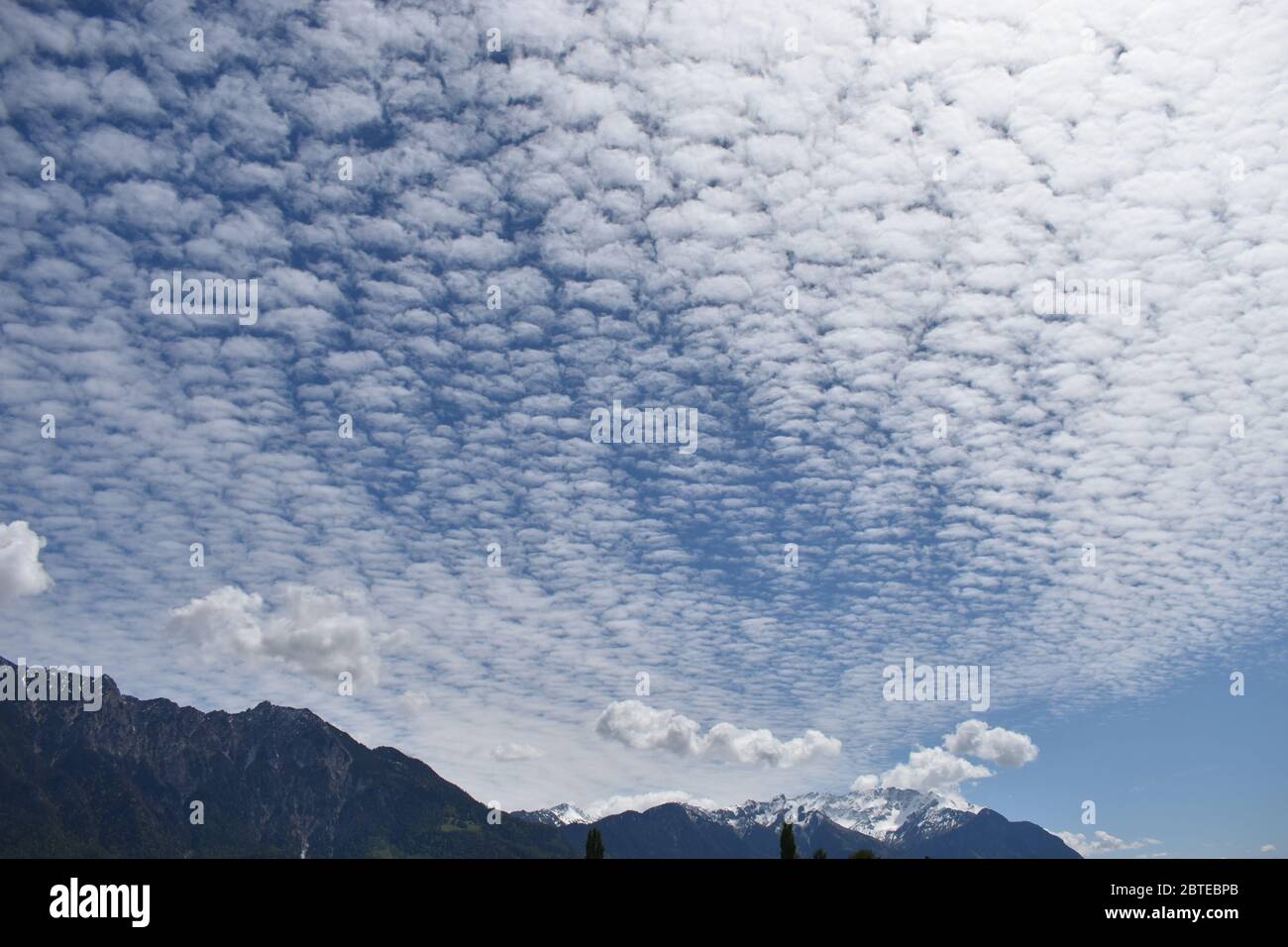 Altocumulus cloud in the blue sky Stock Photo - Alamy
