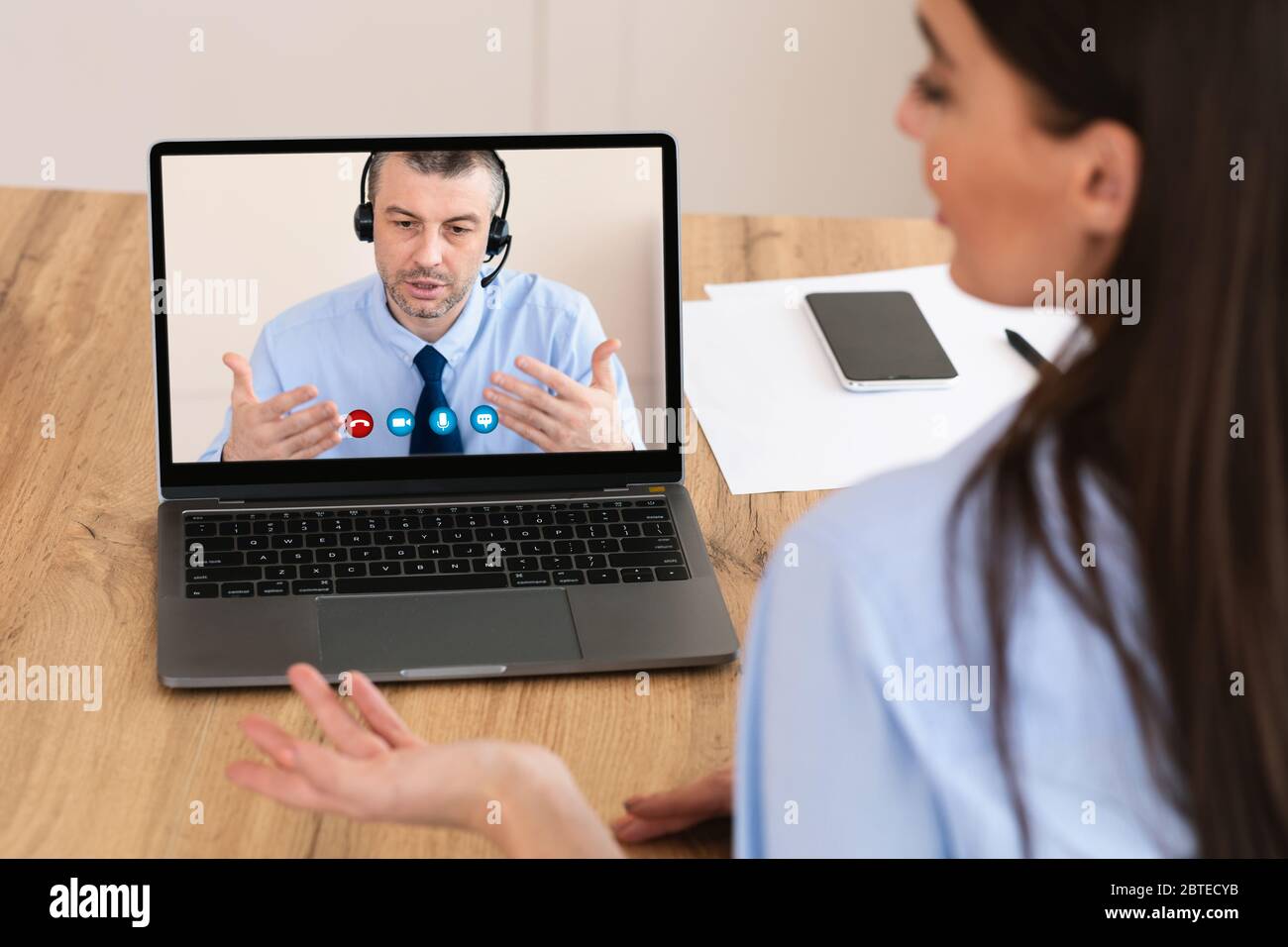 Workers having discussion during video call at home Stock Photo