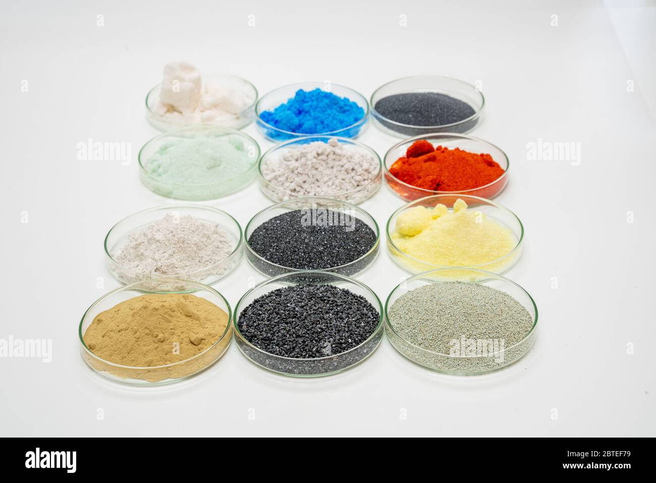 Examples of dry bulk chemical elements in petri dishes on a white