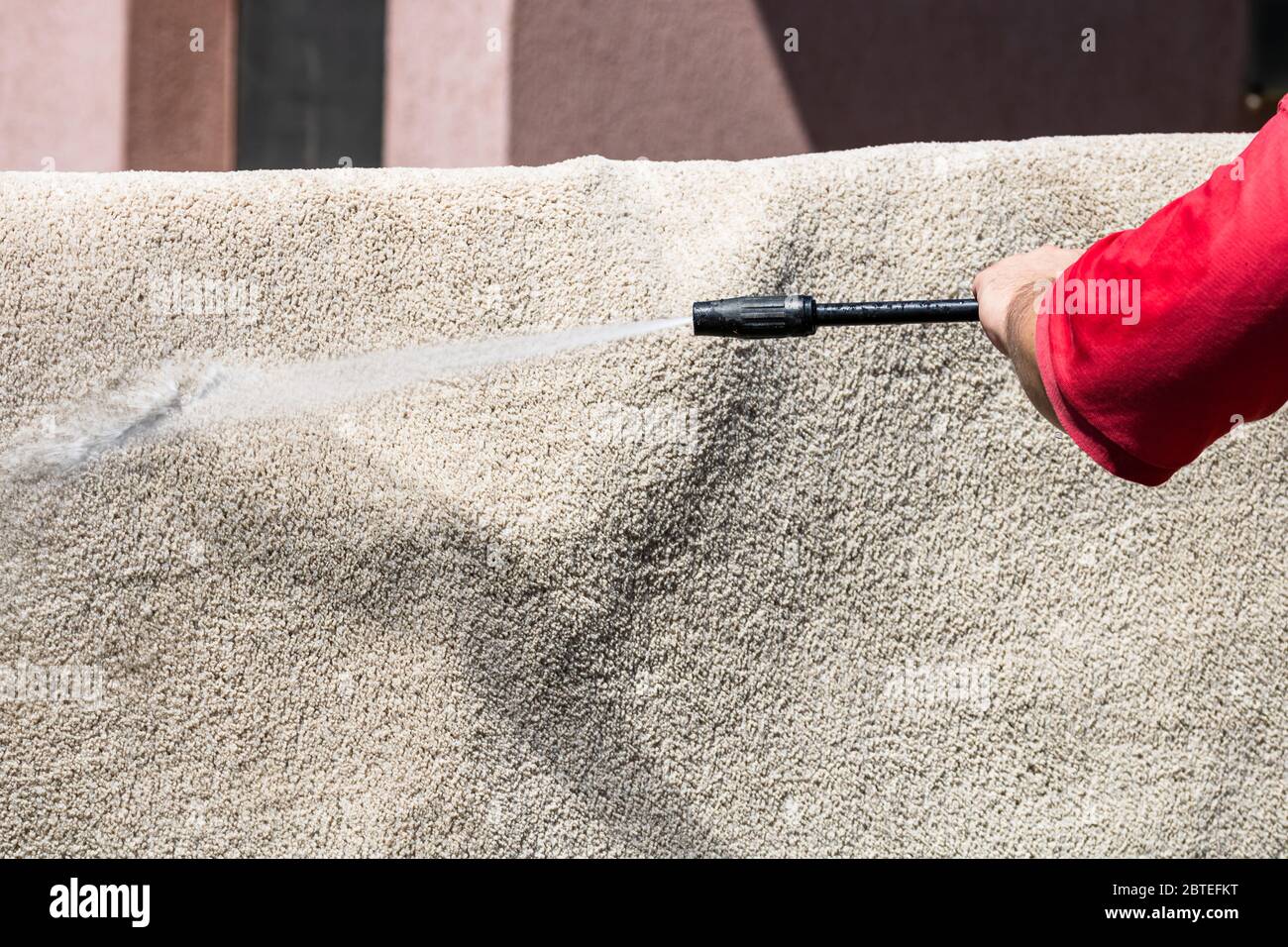 Close up of washing carpets with high pressure washer. Cleaning the