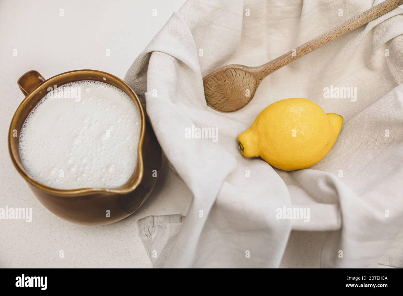 fresh cheese making recipe ingredients, milk, lemon and a cotton cloth, cheesemaking at home Stock Photo