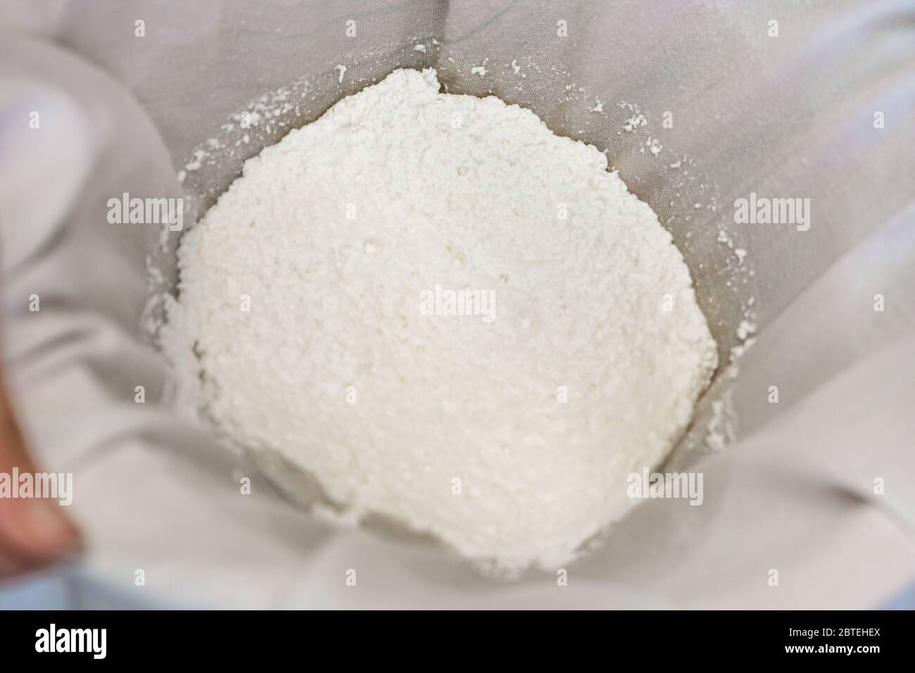 Fresh cheese making process, clotted cheese into a cotton cloth
