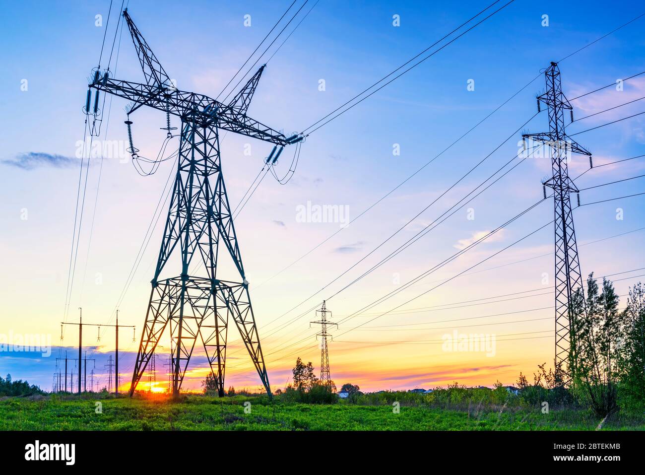 Industrial landscape with high voltage power lines at the sunset Stock Photo