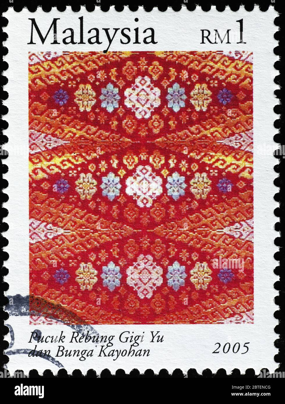 Beautiful malaysian fabric on postage stamp Stock Photo