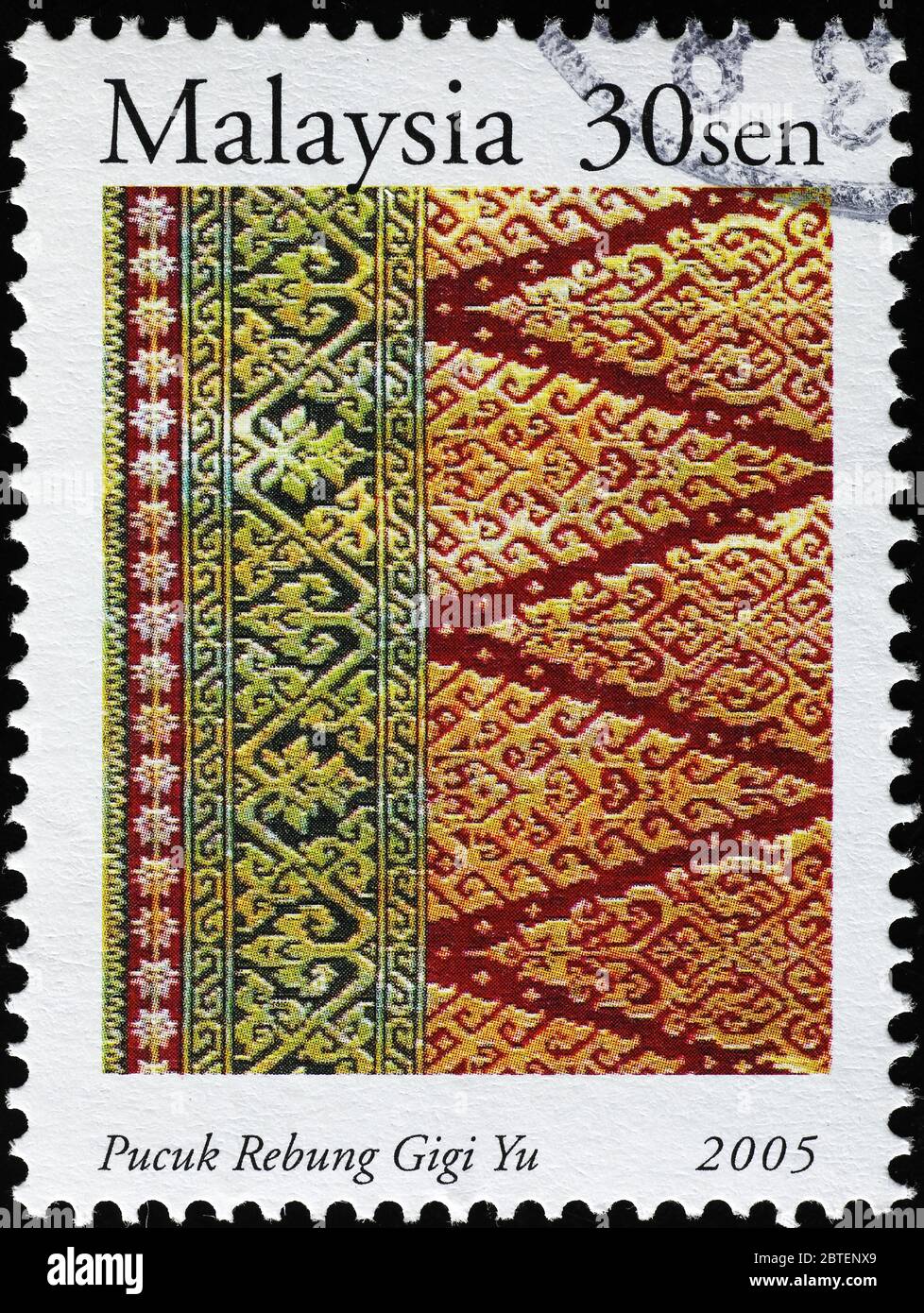 Elaborated malaysian fabric on postage stamp Stock Photo