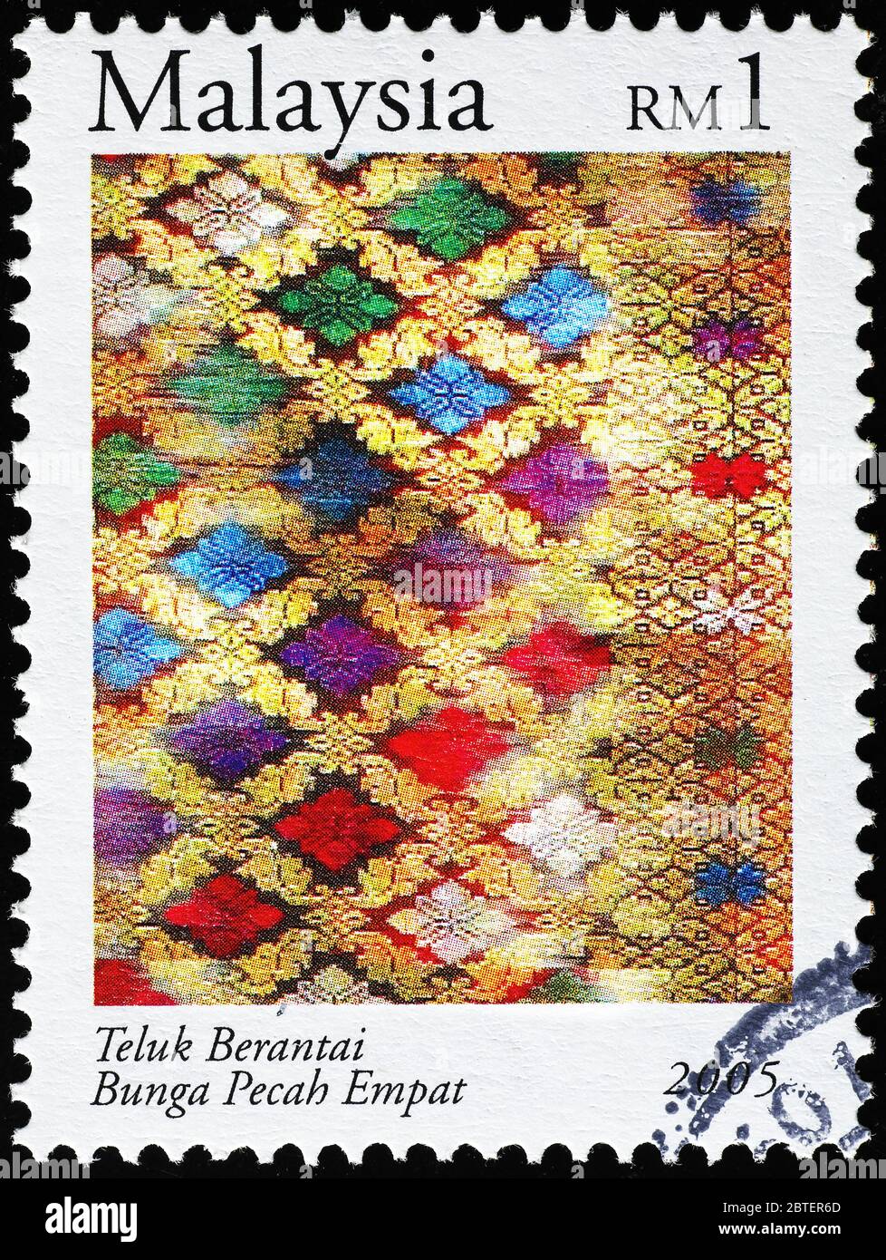 Multicolor malaysian fabric on postage stamp Stock Photo